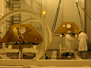 Two GRACE satellites are next to each other in a clean room.