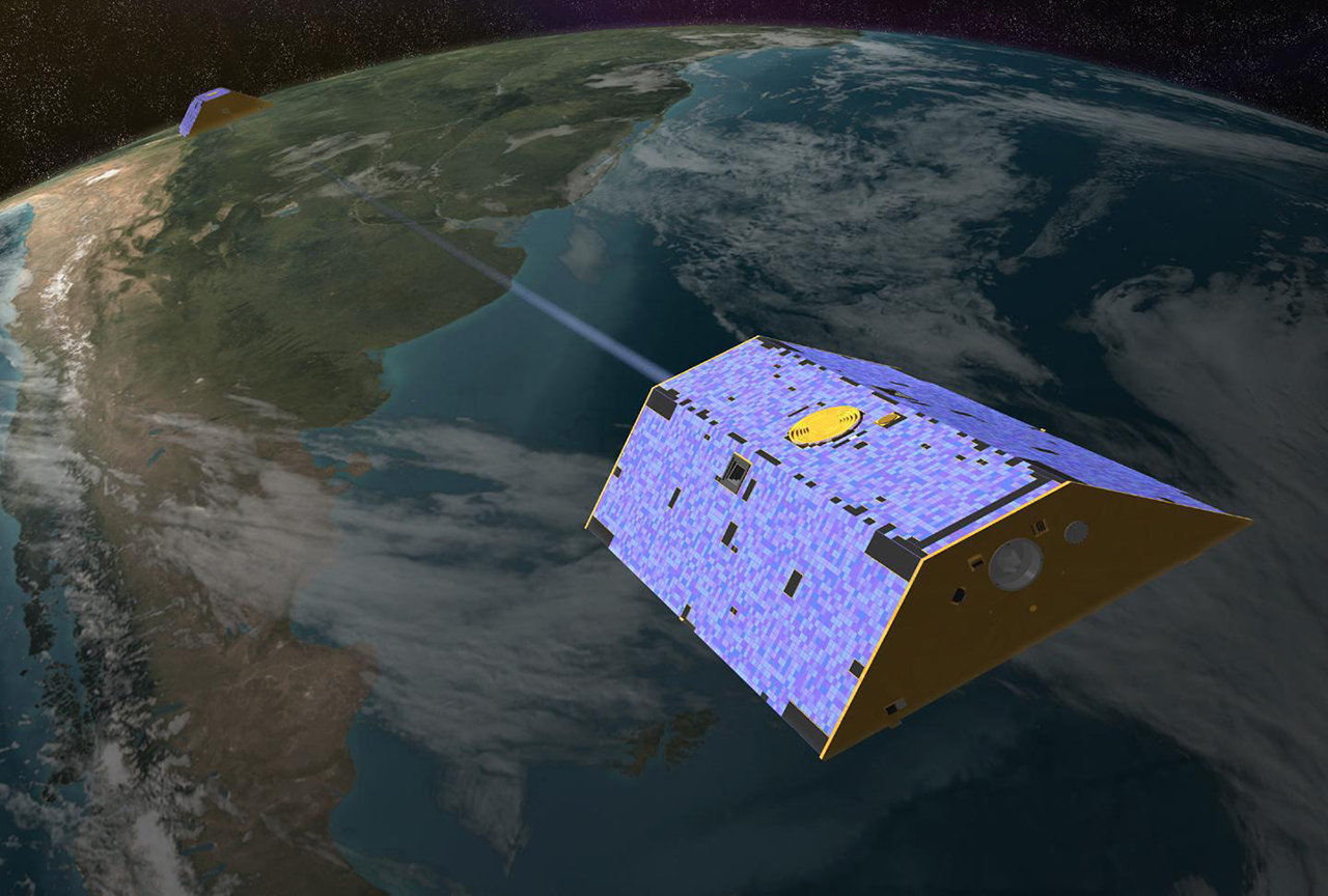 Artist's rendering of the twin Gravity Recovery and Climate Experiment (GRACE) satellites in orbit over Earth. 